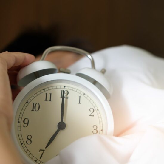 Holding the alarm clock while sleeping